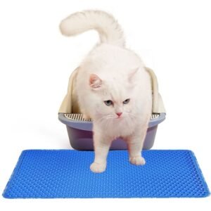 White cat stepping onto a blue EVA cat litter mat next to a litter box